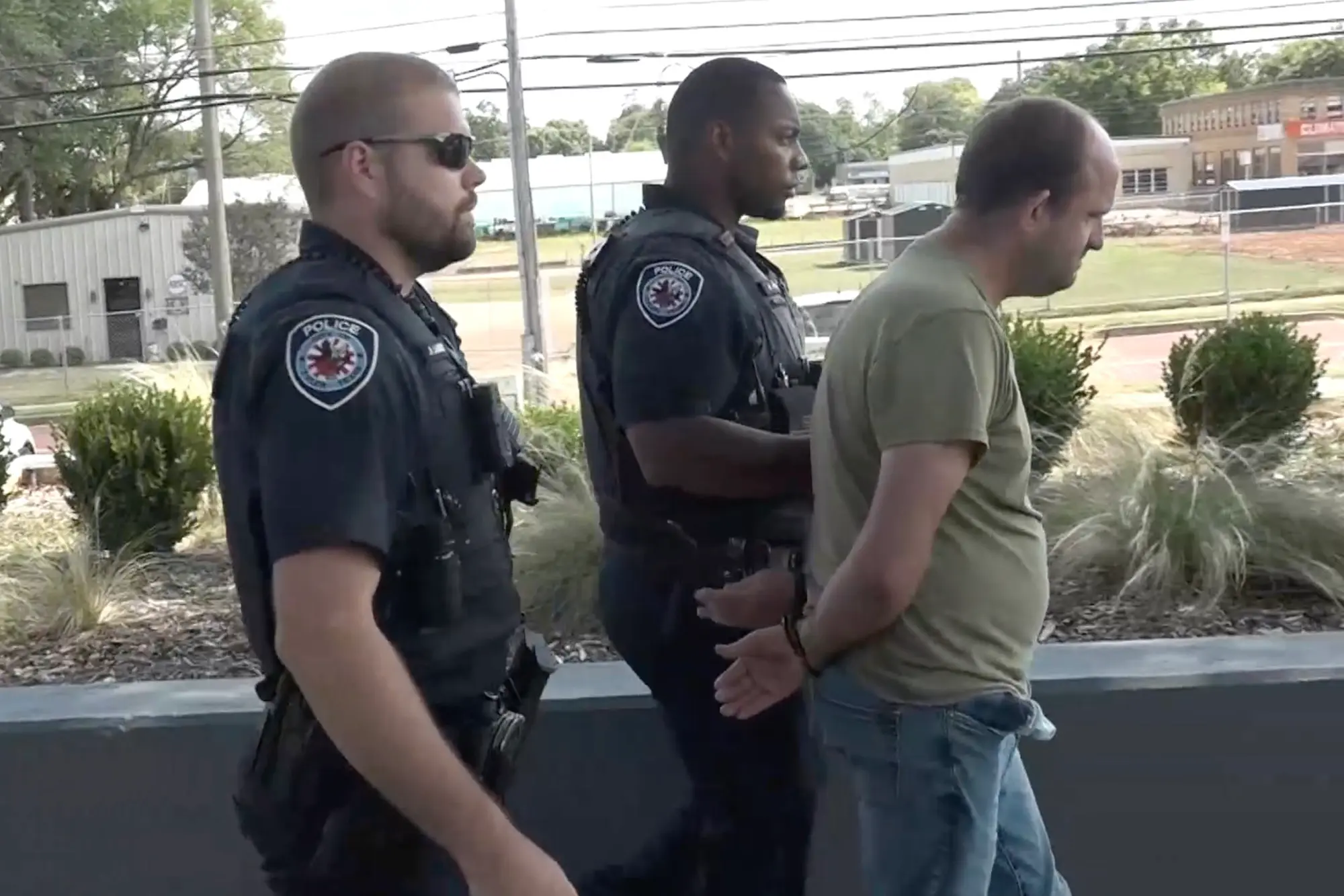 Wesley Worl walked to a transport vehicle in handcuffs